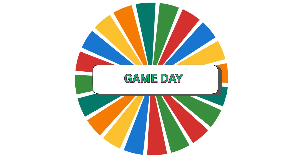 A colorful spinning wheel features alternating green, red, yellow, and blue segments, with a white rectangle at the center proudly displaying GAME DAY in bold green letters—setting an exciting tone for your next game day event.